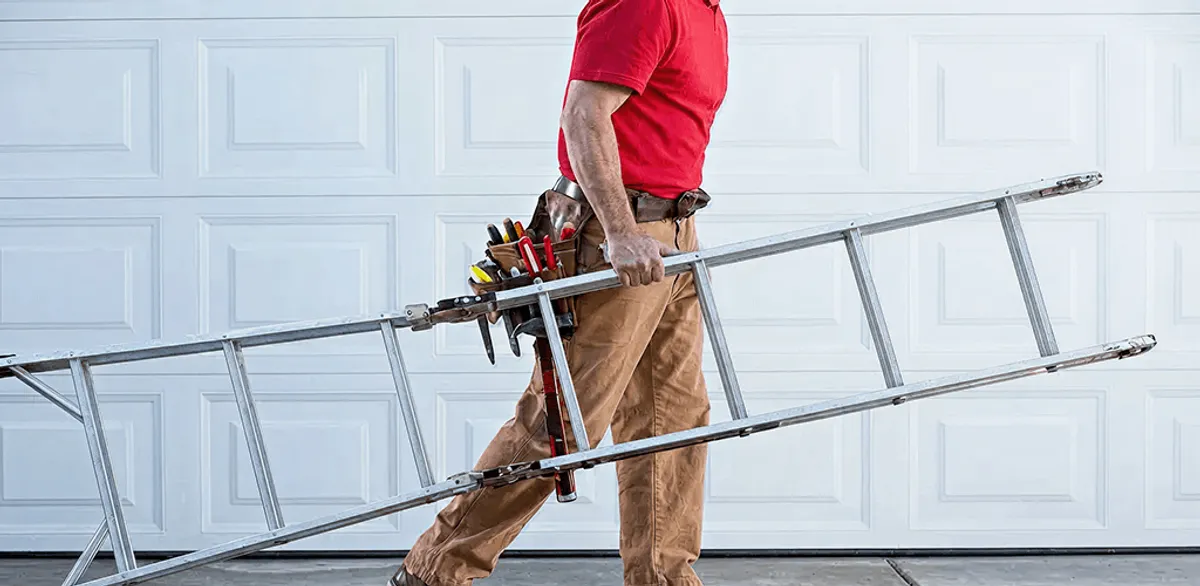 Garage door repair technician arriving with tools and ladder in Pittsburgh, PA